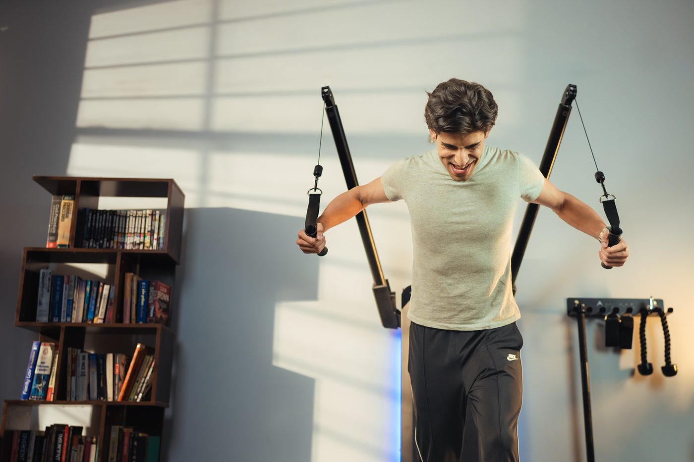 A user training with both arms extended on Aroleap X, showing the working area around the machine