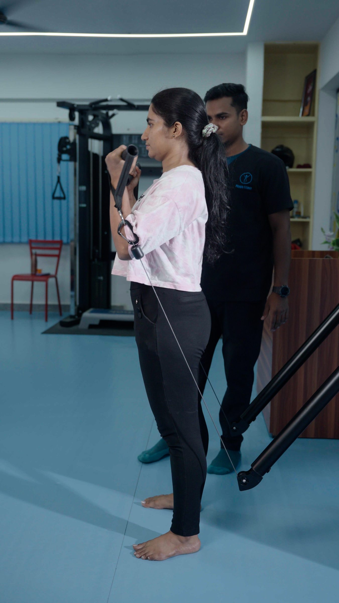 A patient performing a standing cable exercise on Aroleap