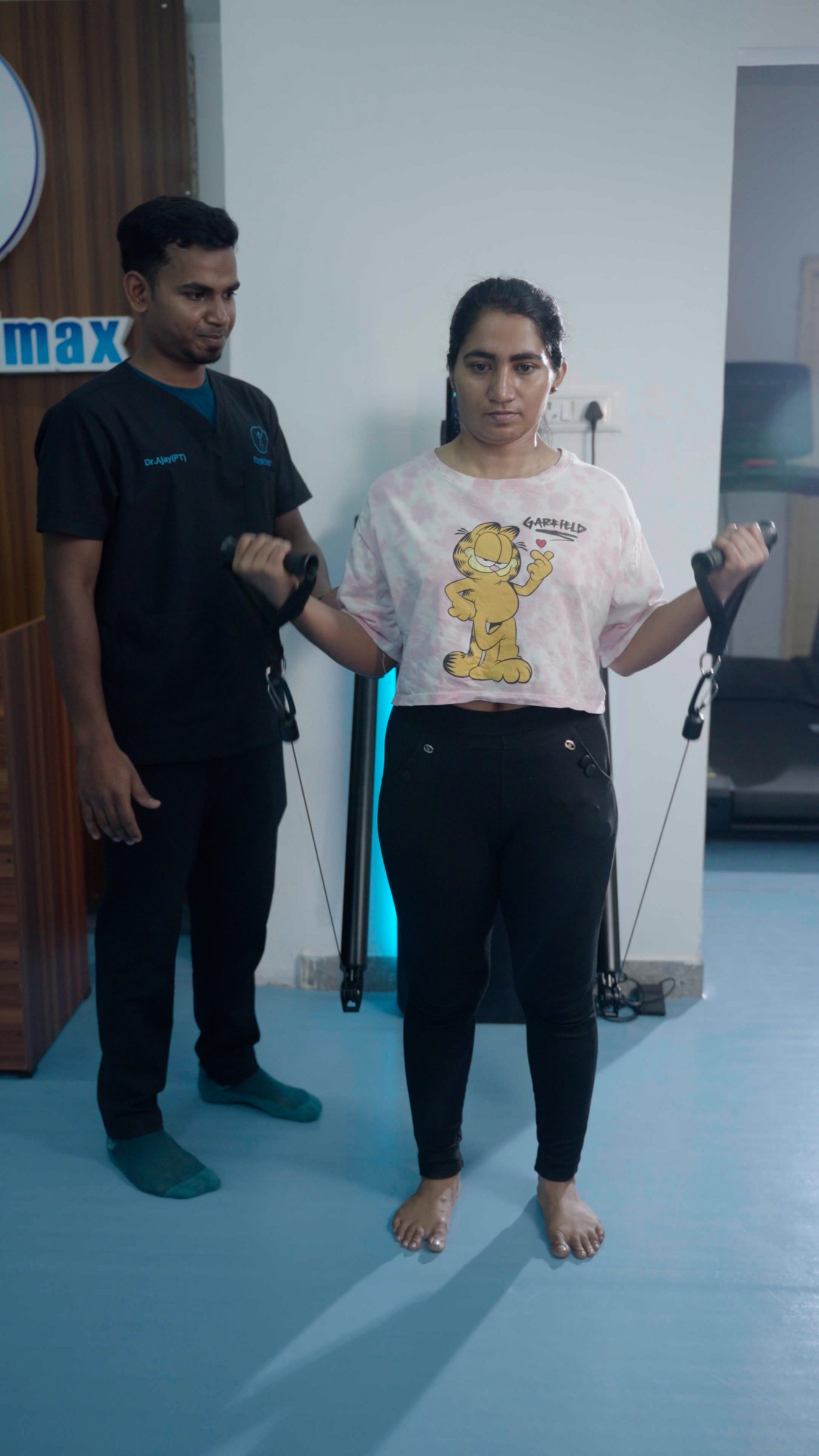 A patient performing a standing exercise under supervision
